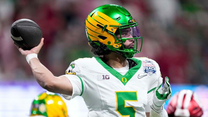 Oregon Ducks quarterback Dante Moore (5) draws back to pass Friday, Jan. 9, 2026, during the Peach Bowl and semifinal game of the College Football Playoff against the Indiana Hoosiers at Mercedes-Benz Stadium in Atlanta.