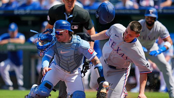 Texas Rangers shortstop Corey Seager (5) collides with Kansas City Royals catcher Carter Jensen (22).