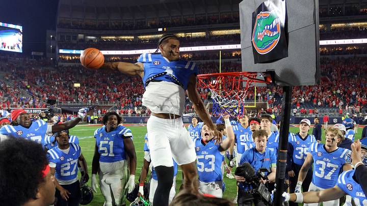 Mississippi Rebels tight end Caleb Odom dunks on a basketball goal after defeating the Florida Gators at Vaught-Hemingway Stadium. Mandatory Credit: Petre Thomas-Imagn Images
