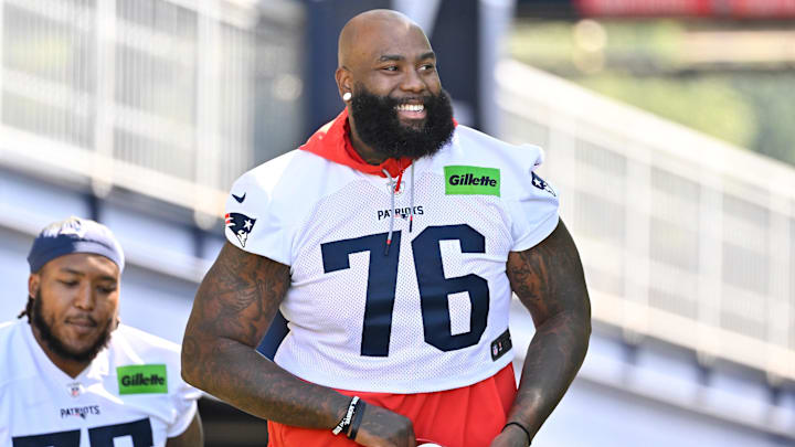 Jul 23, 2025; Foxborough, MA, USA; New England Patriots offensive tackle Morgan Moses (76) walks to the practice field for training camp at Gillette Stadium. Mandatory Credit: Eric Canha-Imagn Images