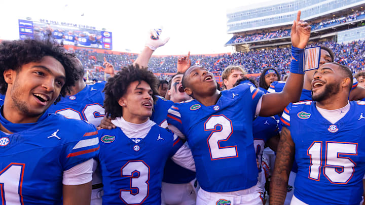 Florida Gators quarterback DJ Lagway (2) celebrates at Ben Hill Griffin Stadium with teammates Florida Gators running back Florida Gators wide receiver Aidan Mizell (11), Florida Gators wide receiver Eugene Wilson III (3) and Florida Gators linebacker Derek Wingo (15) in Gainesville, FL on Saturday, November 23, 2024. The Gators defeated the Rebels 24-17 [Doug Engle/Gainesville Sun]