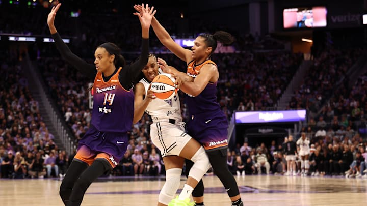 Jul 14, 2025; San Francisco, California, USA; Golden State Valkyries forward Kayla Thornton (5) controls the ball between Phoenix Mercury guard DeWanna Bonner (14) and forward Alyssa Thomas (25) during the fourth quarter at Chase Center. Mandatory Credit: Kelley L Cox-Imagn Images