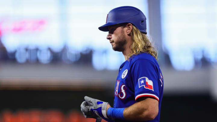 Jun 2, 2024; Miami, Florida, USA; Texas Rangers right fielder Travis Jankowski (16) looks on from first base after hitting a single against the Miami Marlins during the eighth inning at loanDepot Park. 