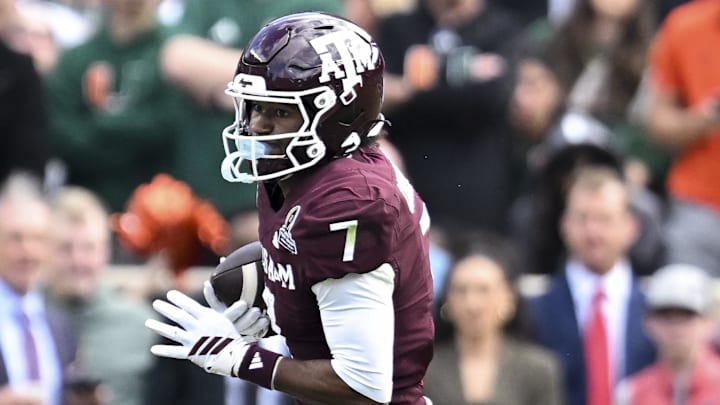 Dec 20, 2025; College Station, TX, USA; Texas A&M Aggies wide receiver KC Concepcion (7) runs the ball against the Miami Hurricanes during the second half at Kyle Field.  
