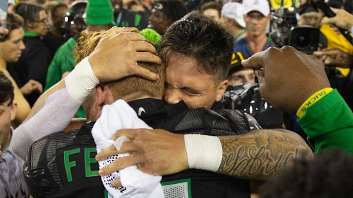Oregon quarterback Dillon Gabriel celebrates with Terrance Ferguson and Duck fans after defeating Ohio State 32-31 at Autzen Stadium Saturday, Oct. 12, 2024. Oregon quarterback Dillon Gabriel celebrates with Terrance Ferguson and Duck fans after defeating Ohio State 32-31 at Autzen Stadium Saturday, Oct. 12, 2024.