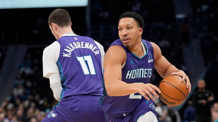 Charlotte Hornets forward Grant Williams (2) handles the ball around center Ryan Kalkbrenner Charlotte Hornets forward Grant Williams (2) handles the ball around center Ryan Kalkbrenner