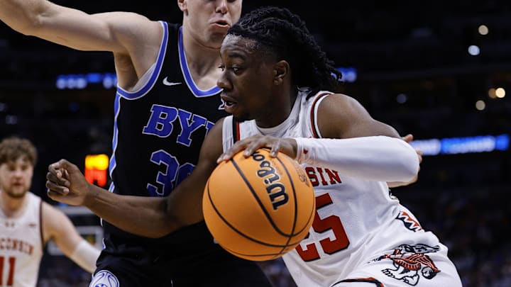 Mar 22, 2025; Denver, CO, USA; Wisconsin Badgers guard John Blackwell (25) dribbles the ball against the Brigham Young Cougars during the first half in the second round of the NCAA Tournament at Ball Arena. 