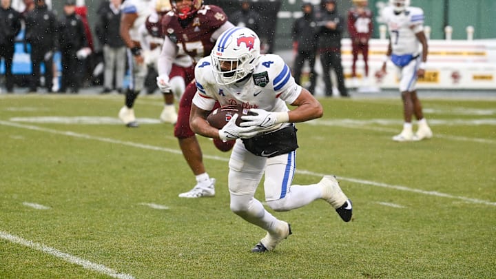 Dec 28, 2023; Boston, MA, USA; Southern Methodist Mustangs running back Jaylan Knighton (4) runs the ball against the Boston College Eagles during the first half at Fenway Park. Mandatory Credit: Eric Canha-Imagn Images
