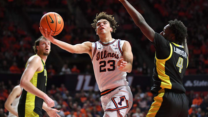 Mar 3, 2026; Champaign, Illinois, USA; Illinois Fighting Illini guard Keaton Wagler (23) drives past Oregon Ducks forward Dezdrick Lindsay (4) during the first half at State Farm Center. Mandatory Credit: Ron Johnson-Imagn Images