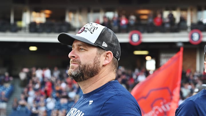 Sep 28, 2025; Cleveland, Ohio, USA;  Cleveland Guardians manager Stephen Vogt (12) watches the flag raising after the Guardians beat the Texas Rangers and won the American League Central Division at Progressive Field. Mandatory Credit: Ken Blaze-Imagn Images