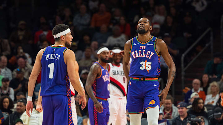 Dec 15, 2024; Phoenix, Arizona, USA; Phoenix Suns guard Devin Booker (1) and forward Kevin Durant (35) react between plays in the second half during a game against the Portland Trail Blazers at Footprint Center. Mandatory Credit: Allan Henry-Imagn Images
