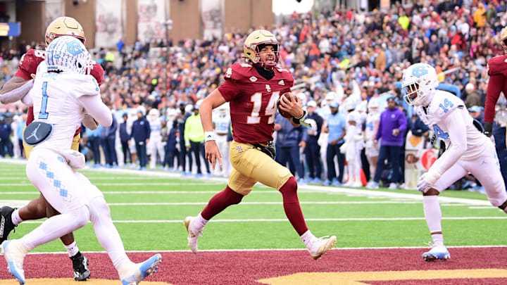 Nov 23, 2024; Chestnut Hill, Massachusetts, USA;  Boston College Eagles quarterback Grayson James (14) runs the ball for a touchdown against the North Carolina Tar Heels during the first half at Alumni Stadium. Mandatory Credit: Eric Canha-Imagn Images