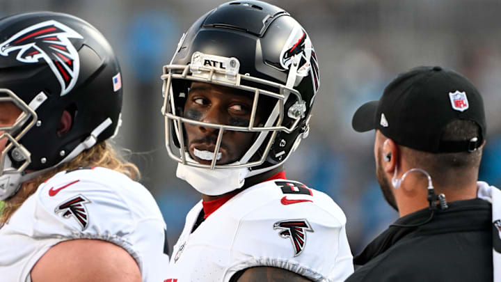 Atlanta Falcons tight end Kyle Pitts (8) talks to a coach on the sidelines in the second quarter at Bank of America Stadium.