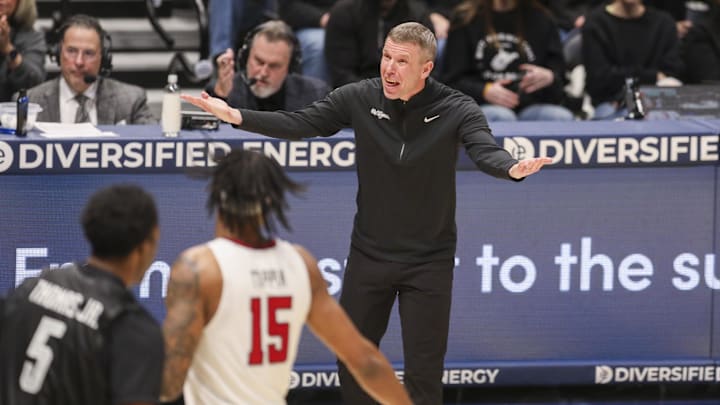 Feb 8, 2026; Morgantown, West Virginia, USA; West Virginia Mountaineers head coach Ross Hodge yells from the sideline during the first half against the Texas Tech Red Raiders at Hope Coliseum. Mandatory Credit: Ben Queen-Imagn Images