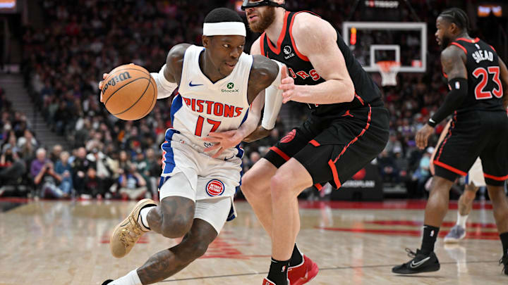 Apr 4, 2025; Toronto, Ontario, CAN;  Detroit Pistons guard Dennis Schroder (17) dribbles the ball around Toronto Raptors forward Jamison Battle (77) in the first half at Scotiabank Arena. Mandatory Credit: Dan Hamilton-Imagn Images
