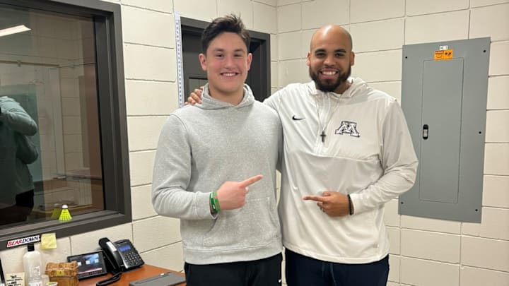 Gage Geyer with Gophers defensive line coach C.J. Robbins.