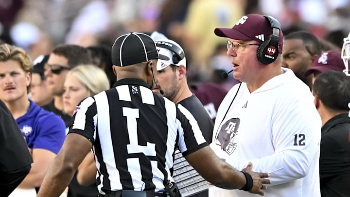 Texas A&M Aggies head coach Mike Elko speaks with line judge Jeremiah Harris during the second half at Kyle Field. 