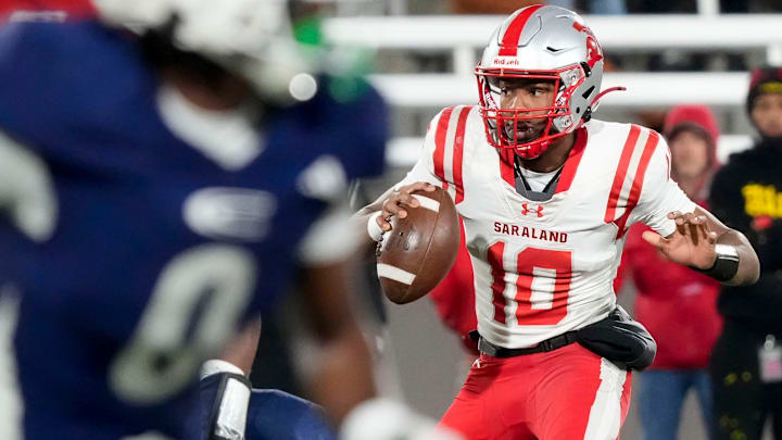 Dec 5, 2025; Birmingham, AL, USA; Saraland's Jamison Roberts (10) escapes a pass rush to throw a touchdown pass at the end of the first half against Clay-Chalkville at Protective Life Stadium in the AHSAA 6A State Championship game.