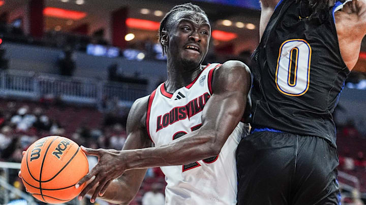 Louisville Cardinals forward Aboubacar Traore (25) looks to pass around Spalding University's Caden Bradford (0) at the KFC Yum! Center in Louisville, Kentucky Monday, Oct. 28, 2024.