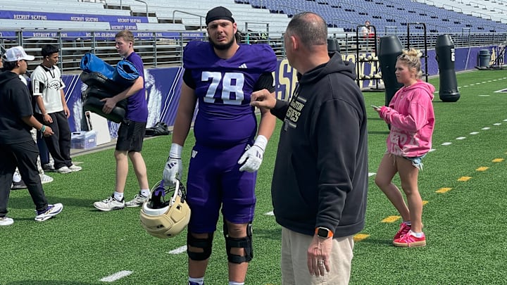 Jake Flores pauses for a moment before entering the Husky locker room.