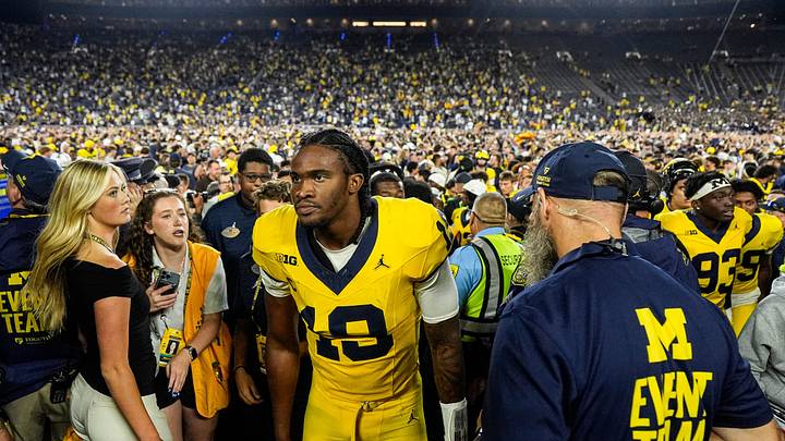 Michigan quarterback Bryce Underwood (19), center, exits the field with Director of Player Personnel Ron Bellamy after 13-12 win over Western Michigan at Michigan Stadium in Ann Arbor on Saturday, Sept. 5, 2026.