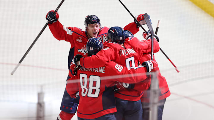 Apr 4, 2025; Washington, District of Columbia, USA; Washington Capitals left wing Alex Ovechkin (8) celebrates with teammates after scoring a goal against the Chicago Blackhawks in the third period at Capital One Arena. The goal is the 894th of his career, tying Wayne Gretzky (not pictured) for most all-time goals scored in the NHL. Mandatory Credit: Amber Searls-Imagn Images