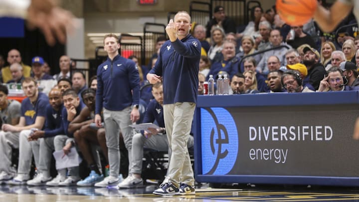 West Virginia Mountaineers head coach Darian DeVries calls out a play during the first half against the UCF Knights at WVU Coliseum. Nick Norton, one of the assistant coaches added to DeVries' Indiana staff, is standing in the background. West Virginia Mountaineers head coach Darian DeVries calls out a play during the first half against the UCF Knights at WVU Coliseum. Nick Norton, one of the assistant coaches added to DeVries' Indiana staff, is standing in the background.