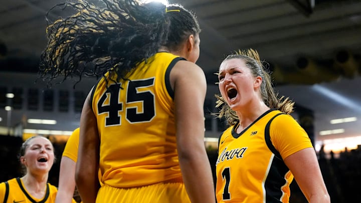 Iowa guard Taylor McCabe (2), Iowa forward Hannah Stuelke (45) and Iowa guard Taylor Stremlow (1) react during a basketball game against the Nebraska Cornhuskers Jan. 1, 2026 at Carver-Hawkeye Arena in Iowa City, Iowa.