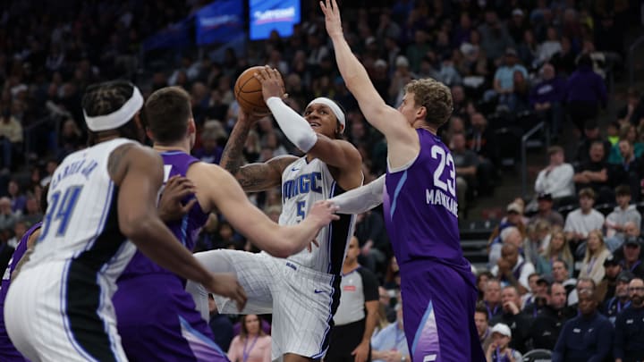 Orlando Magic forward Paolo Banchero (5) shoots the ball against Utah Jazz forward Lauri Markkanen (23) during the second quarter at Delta Center.