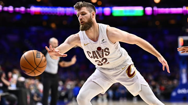 Feb 23, 2024; Philadelphia, Pennsylvania, USA; Cleveland Cavaliers forward Dean Wade (32) reaches for a loose ball against the Philadelphia 76ers in the first quarter at Wells Fargo Center. Mandatory Credit: Kyle Ross-Imagn Images