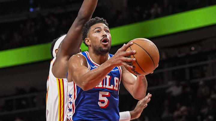 Mar 10, 2025; Atlanta, Georgia, USA; Philadelphia 76ers guard Quentin Grimes (5) goes to the basket behind Atlanta Hawks forward Onyeka Okongwu (17) during the first half at State Farm Arena. Mandatory Credit: Dale Zanine-Imagn Images