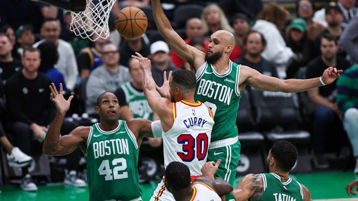 Nov 6, 2024; Boston, Massachusetts, USA; Golden State Warriors guard Stephen Curry (30) passes the ball defended by Boston Celtics guard Derrick White (9) during the first half at TD Garden. Mandatory Credit: Paul Rutherford-Imagn Images