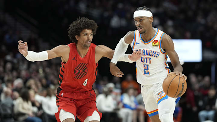 Mar 6, 2024; Portland, Oregon, USA; Oklahoma City Thunder point guard Shai Gilgeous-Alexander (2) dribbles the ball while defended by  Portland Trail Blazers shooting guard Matisse Thybulle (4) during the second half at Moda Center. Mandatory Credit: Soobum Im-USA TODAY Sports