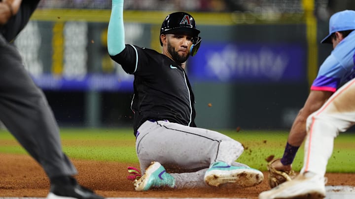 Aug 15, 2025; Denver, Colorado, USA; Arizona Diamondbacks left tfielder Lourdes Gurriel Jr. (12) is thrown out at third in the sixth inning against the Colorado Rockies at Coors Field. Mandatory Credit: Ron Chenoy-Imagn Images