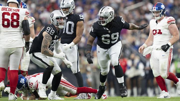 November 5, 2023; Paradise, Nevada, USA; Las Vegas Raiders defensive end Maxx Crosby (98) and defensive tackle Adam Butler (69) celebrate after sacking New York Giants quarterback Tommy DeVito (15) during the third quarter at Allegiant Stadium. Mandatory Credit: Kyle Terada-USA TODAY Sports