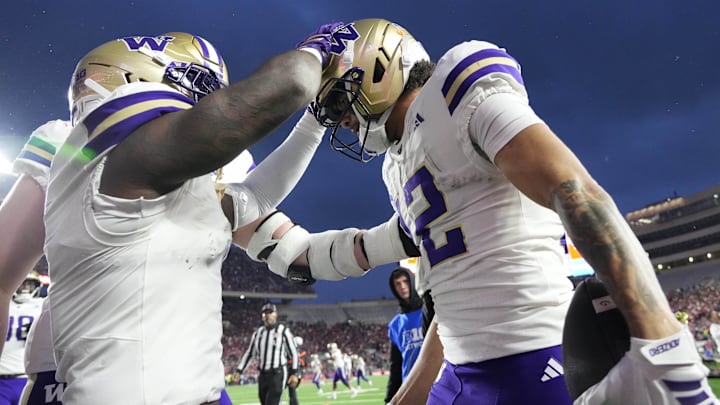 Huskies wide receiver Denzel Boston (12) celebrates a touchdown catch against Wisconsin.