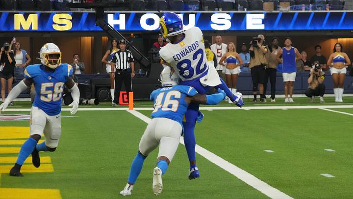 Aug 16, 2025; Inglewood, California, USA; Los Angeles Rams wide receiver Tru Edwards (82) catches an 8-yard touchdown pass against Los Angeles Chargers cornerback Nikko Reed (46) and linebacker Bud Dupree (48) in the fourth quarter at SoFi Stadium. Mandatory Credit: Kirby Lee-Imagn Images