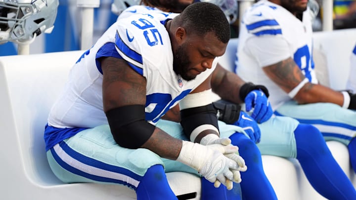 Oct 26, 2025; Denver, Colorado, USA; Dallas Cowboys defensive tackle Kenny Clark (95) reacts on the bench in the second half against the Denver Broncos at Empower Field at Mile High.
