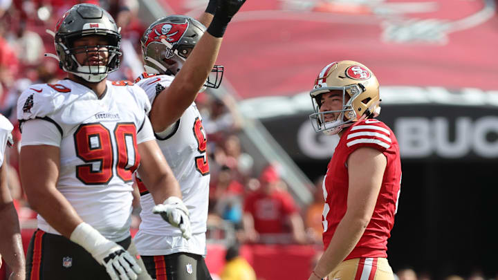 Nov 10, 2024; Tampa, Florida, USA; San Francisco 49ers place kicker Jake Moody (4) misses a field goal as Tampa Bay Buccaneers defensive end Logan Hall (90) and tight end Cade Otton (88) defend during the first half at Raymond James Stadium. Mandatory Credit: Kim Klement Neitzel-Imagn Images