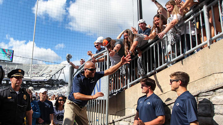 Penn State football coach James Franklin celebrates with students following a Nittany Lions victory at Beaver Stadium.