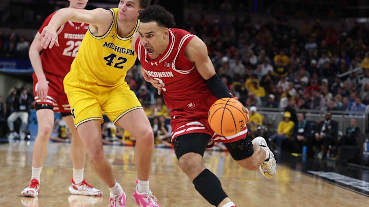 Mar 16, 2025; Indianapolis, IN, USA; Wisconsin Badgers guard John Tonje (9) drives to the hoop past Michigan Wolverines forward Will Tschetter (42) during the second half during the 2025 Big Ten Championship Game at Gainbridge Fieldhouse. Mandatory Credit: Trevor Ruszkowski-Imagn Images