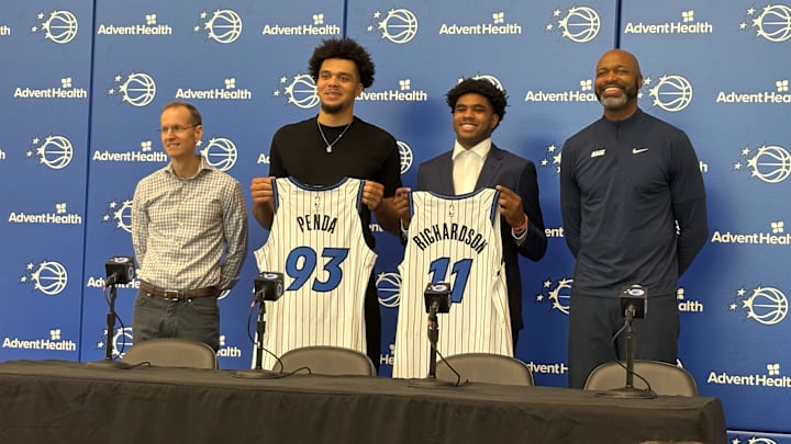 Orlando Magic draft picks Jase Richardson and Noah Penda pose with their jerseys at introductory press conference. 