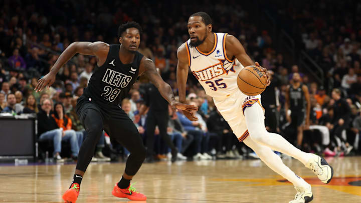 Dec 13, 2023; Phoenix, Arizona, USA; Phoenix Suns forward Kevin Durant (35) against Brooklyn Nets forward Dorian Finney-Smith (28) at Footprint Center. Mandatory Credit: Mark J. Rebilas-Imagn Images