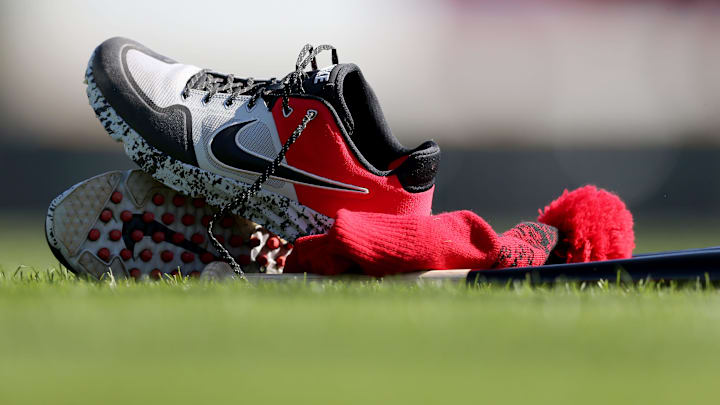 Cincinnati Reds first baseman Joey Votto's (19) shoes, bat and hat rest on the field.