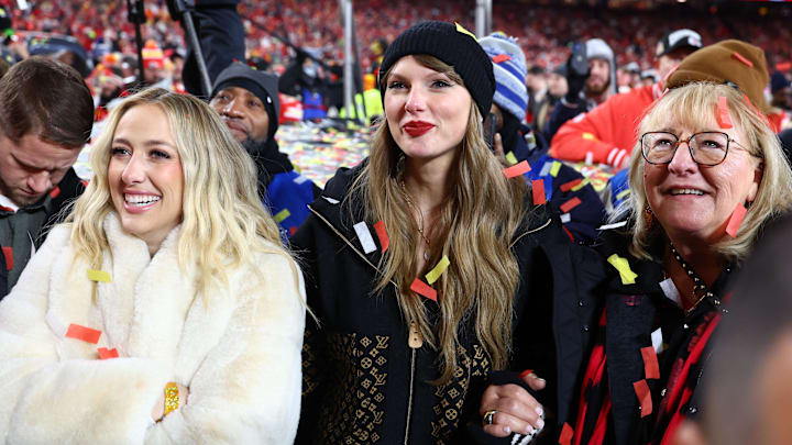 Jan 26, 2025; Kansas City, MO, USA; Recording artist Taylor Swift (center) Brittany Mahomes (left) and Donna Kelce (right) react after the AFC Championship game against the Buffalo Bills at GEHA Field at Arrowhead Stadium.