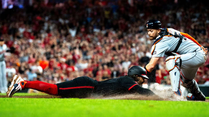 Cincinnati Reds second baseman Jonathan India (6) slides home to score as Detroit Tigers catcher Carson Kelly (15) receives the throw in the sixth inning of the MLB game between the Cincinnati Reds and the Detroit Tigers at Great American Ball Park in Cincinnati on Friday, July 5, 2024.
