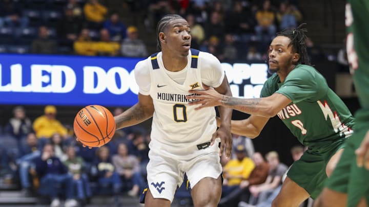 Dec 22, 2025; Morgantown, West Virginia, USA; West Virginia Mountaineers forward Brenen Lorient (0) looks to pass around Mississippi Valley State Delta Devils guard Patrick Punch (0) during the second half at Hope Coliseum. Mandatory Credit: Ben Queen-Imagn Images