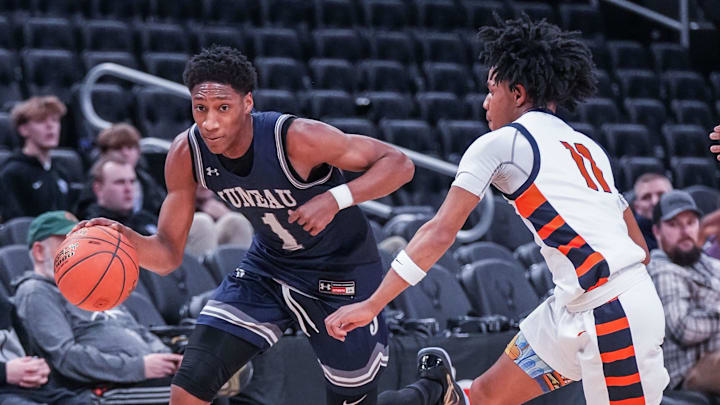 Milwaukee Juneau's Dooney Johnson (1) races Racine Park's Jwan Eastland (11) downcourt during their Deer District Prep Showcase game at Fiserv Forum in Milwaukee, WI. on Saturday, Feb. 8, 2025. Racine Park won the game, 70-55.