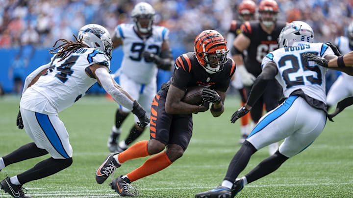 Sep 29, 2024; Charlotte, North Carolina, USA; Cincinnati Bengals wide receiver Tee Higgins (5) runs for yards after catch against Carolina Panthers linebacker Shaq Thompson (54) and safety Xavier Woods (25) during 1st quarter at Bank of America Stadium. Mandatory Credit: Jim Dedmon-Imagn Images Sep 29, 2024; Charlotte, North Carolina, USA; Cincinnati Bengals wide receiver Tee Higgins (5) runs for yards after catch against Carolina Panthers linebacker Shaq Thompson (54) and safety Xavier Woods (25) during 1st quarter at Bank of America Stadium. Mandatory Credit: Jim Dedmon-Imagn Images