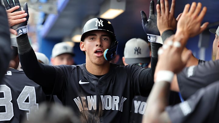 Feb 22, 2025; Dunedin, Florida, USA;  New York Yankees shortstop George Lombard Jr. (96)  is congratulated after he scored a run during the sixth inning against the Toronto Blue Jays at TD Ballpark. 